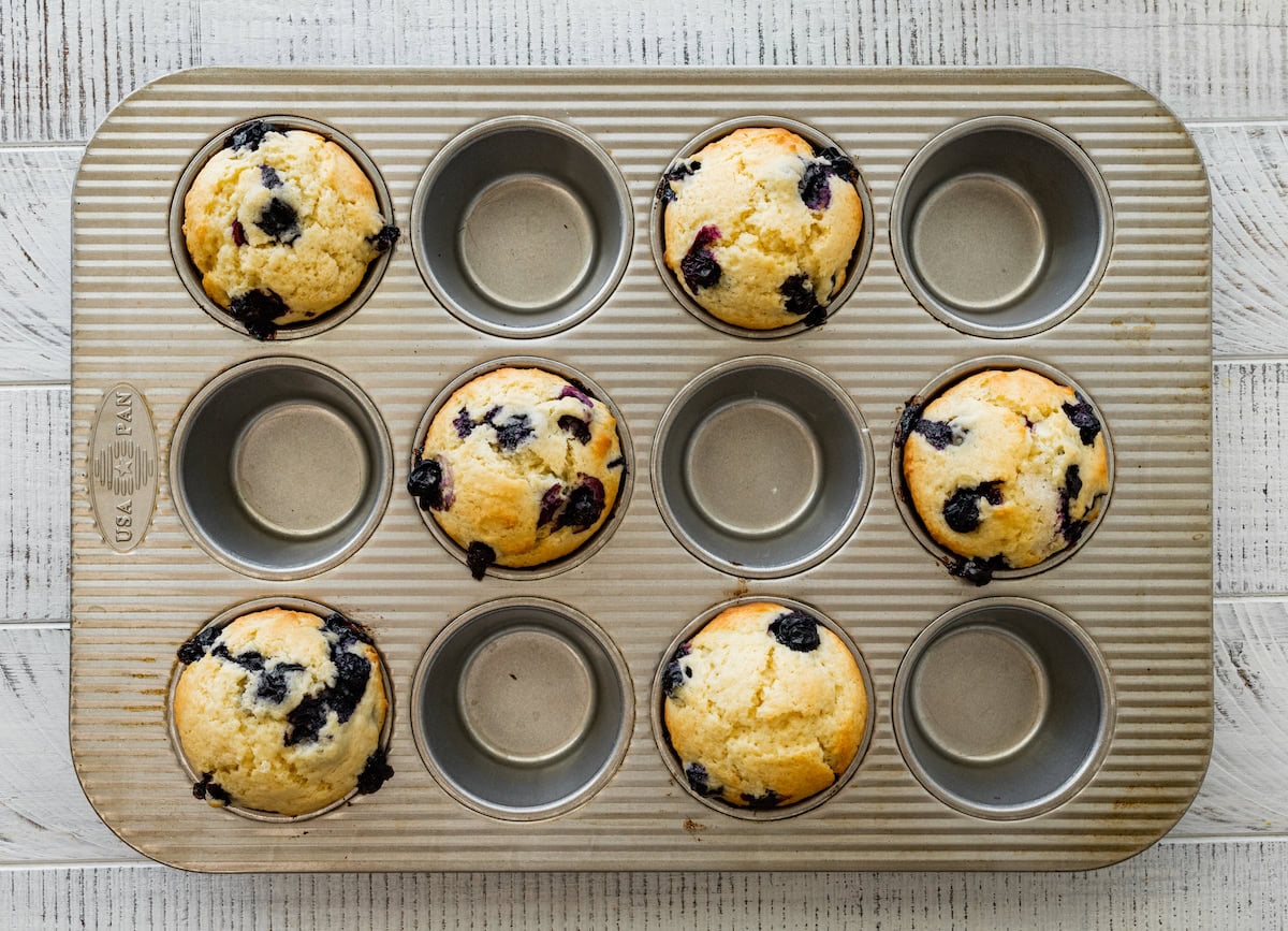 lemon blueberry muffins in muffin pan. 