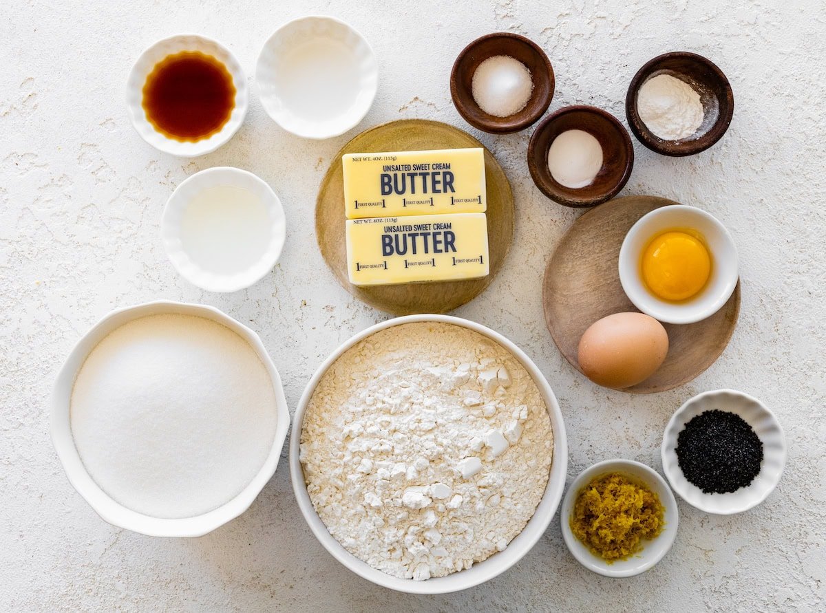 Ingredients in bowls to make lemon poppy seed cookies. 