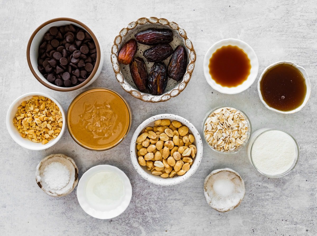 ingredients in bowls to make snickers protein balls.