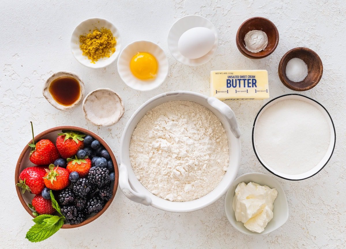 sugar cookie fruit pizza bar ingredients in bowls. 