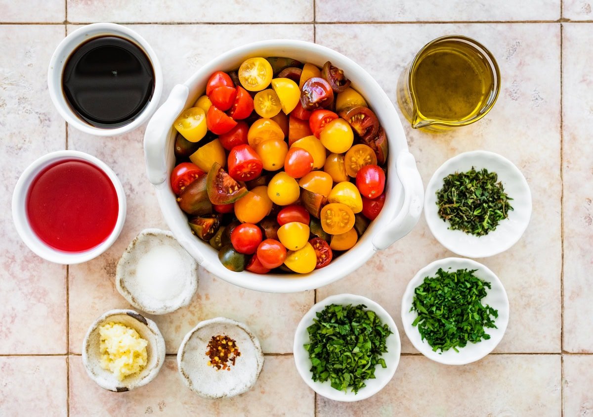 ingredients in bowls to make marinated tomatoes.