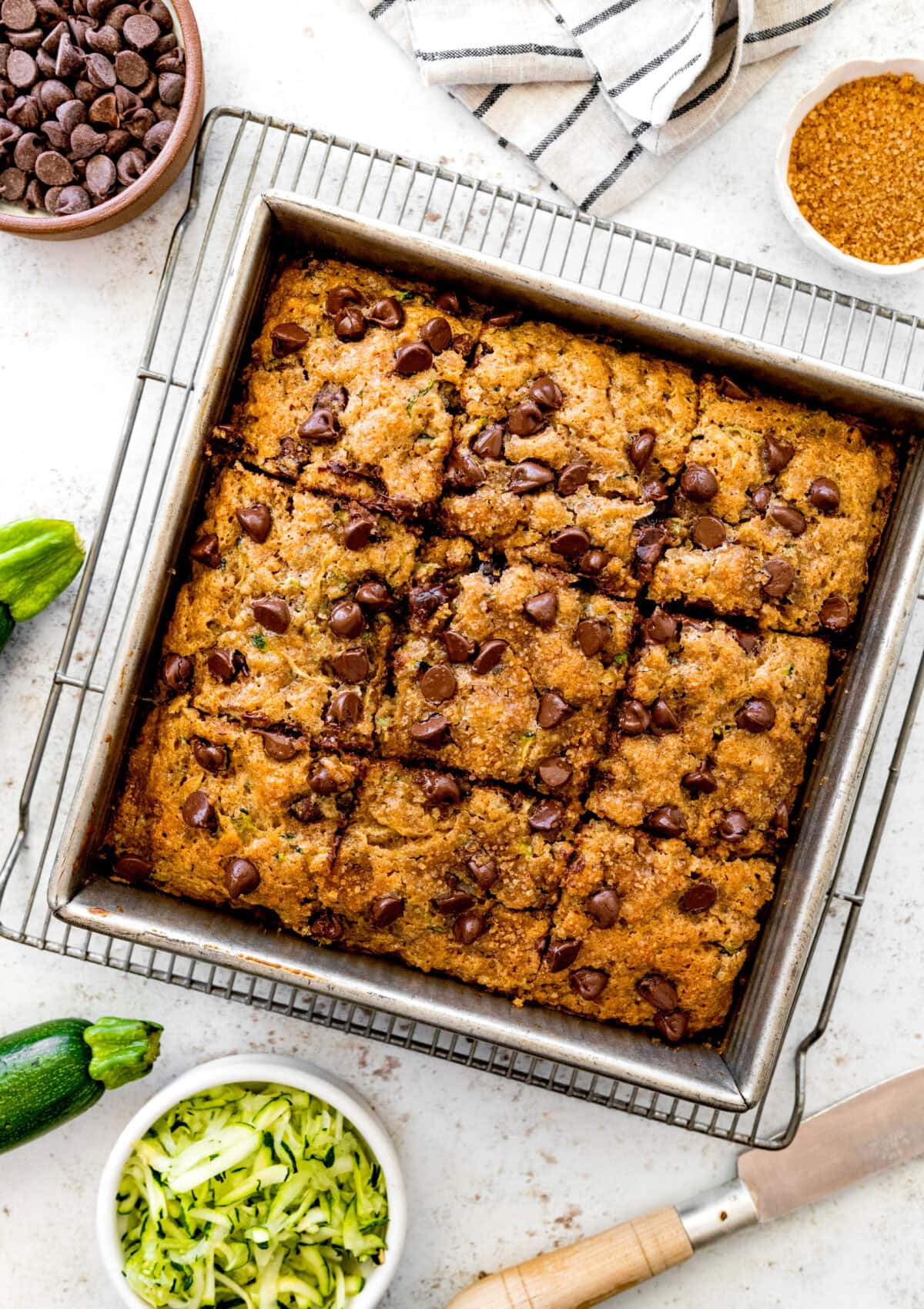 easy chocolate chip zucchini cake in baking pan on cooling rack.