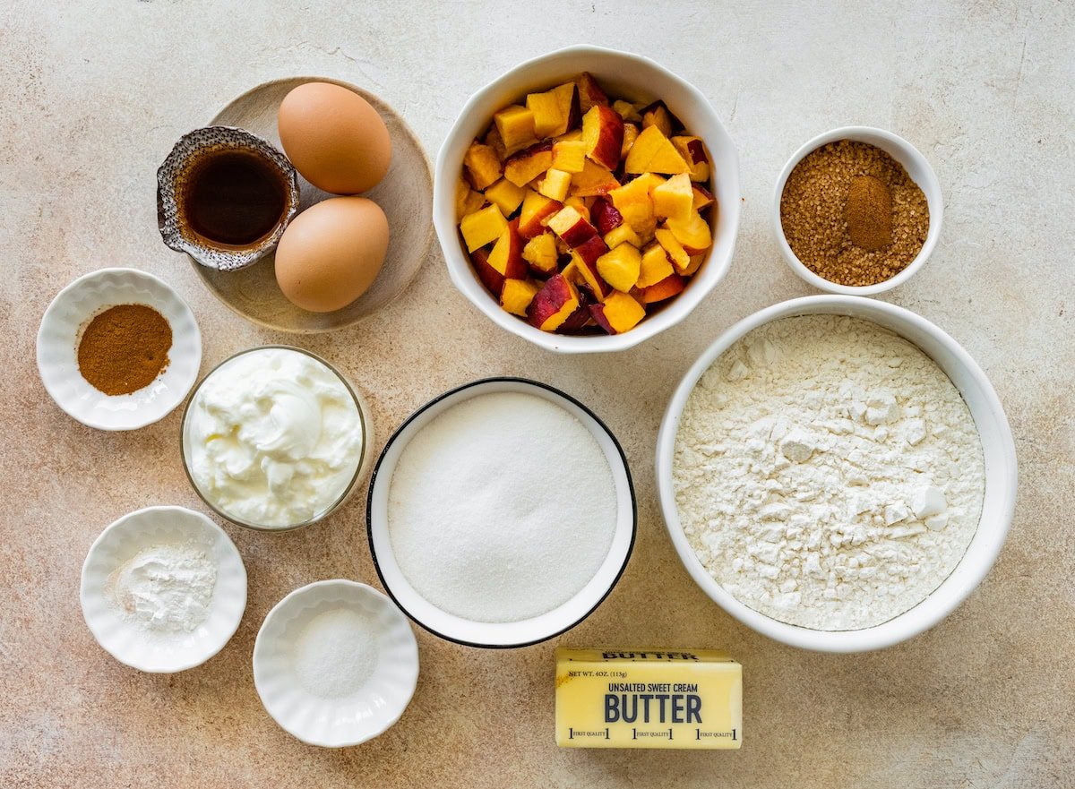 ingredients in bowls to make peach muffins.