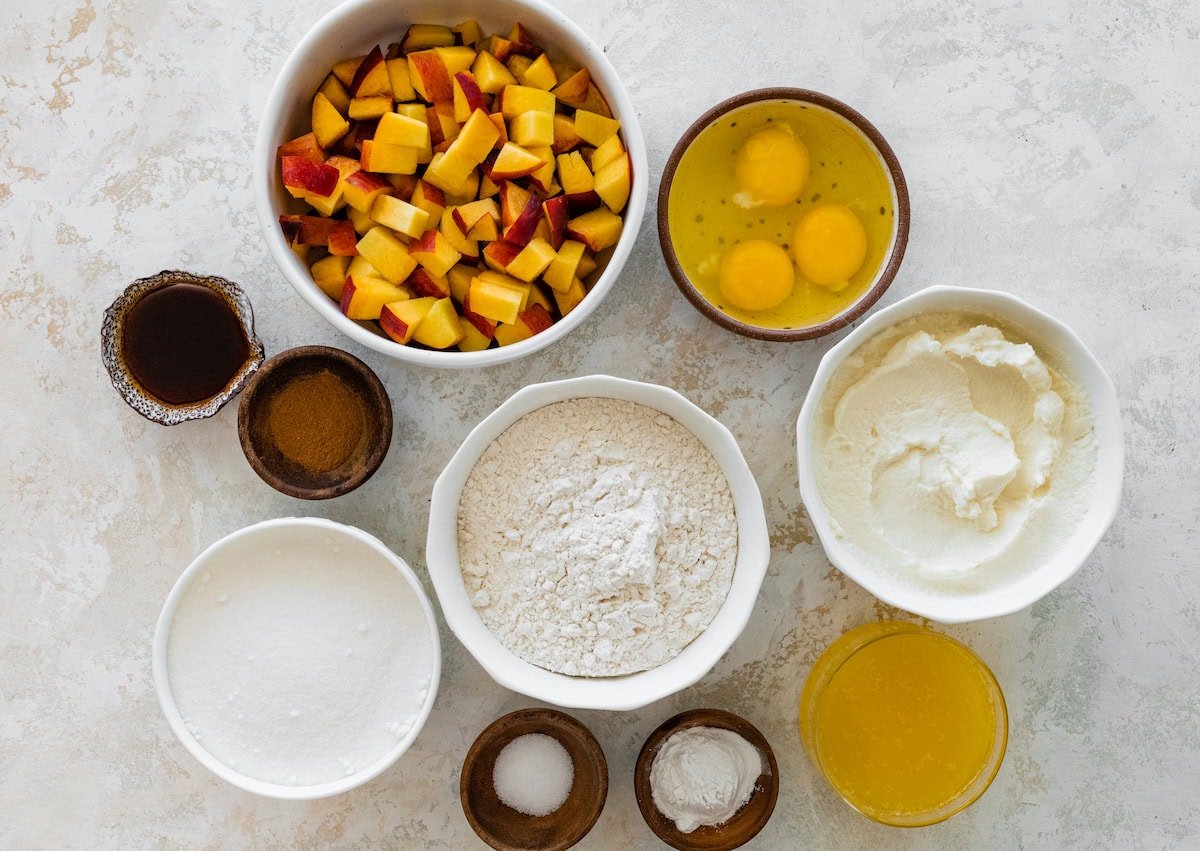 ingredients in bowls to make peach ricotta cake. 
