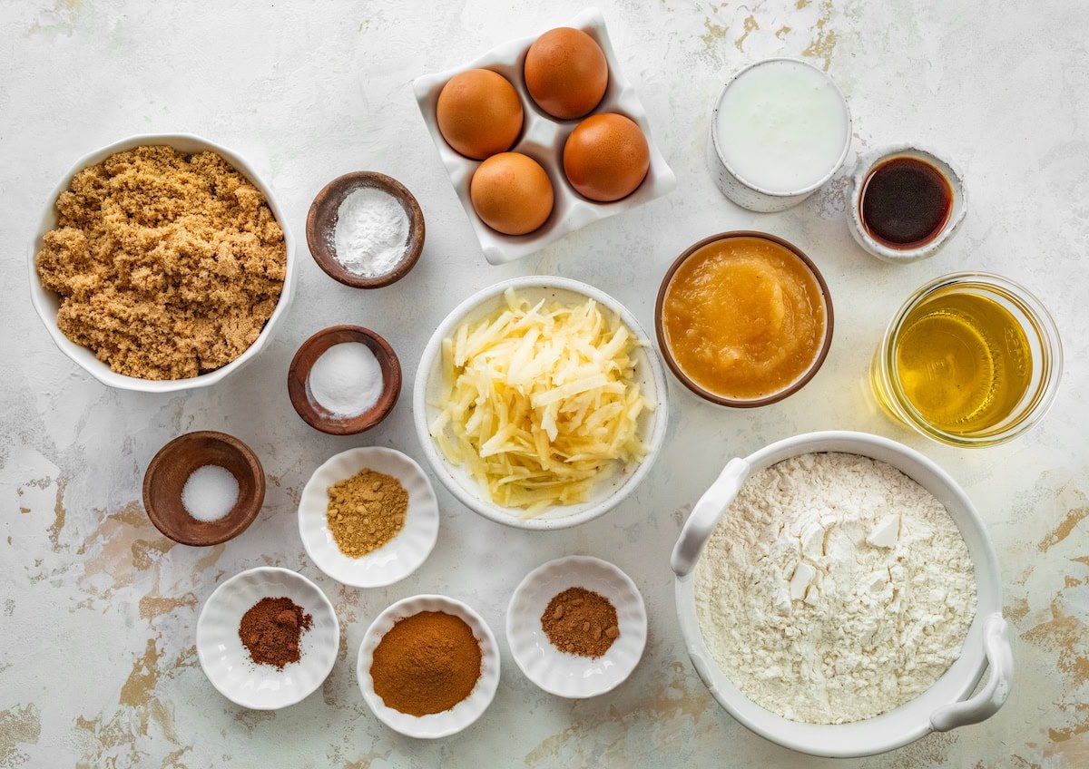 Ingredients in bowls to make apple spice cake with salted caramel cream cheese frosting. 