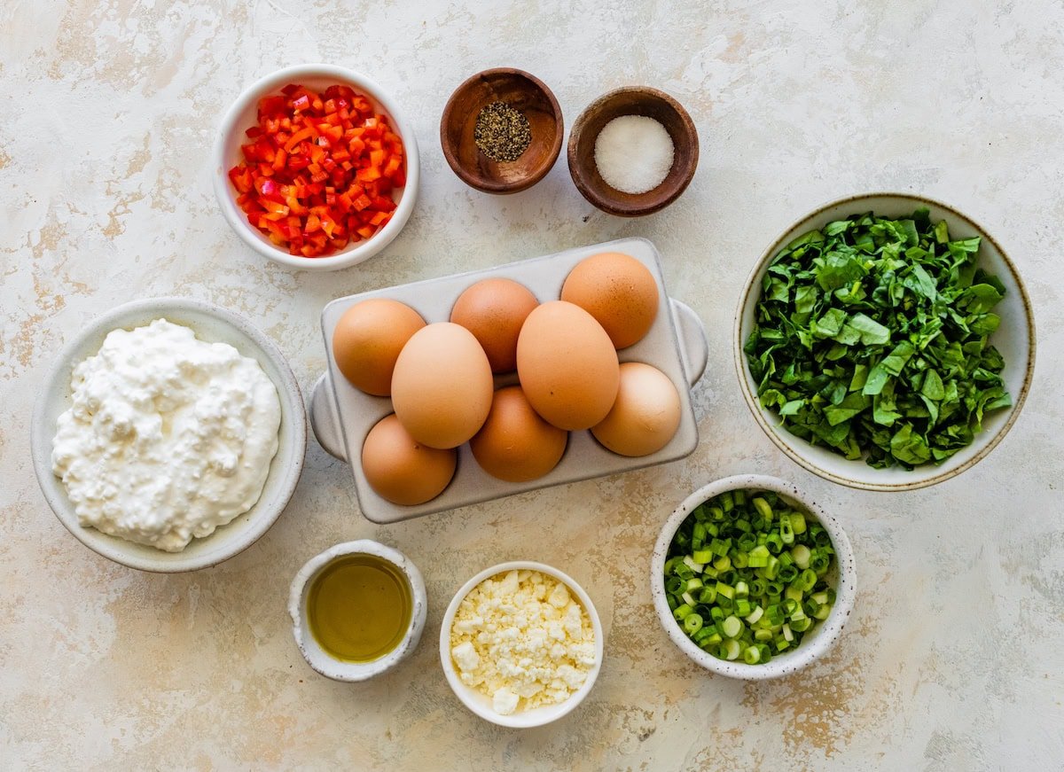 eggs, cottage cheese, red bell pepper, spinach, green onions, feta, oil, salt, and pepper to make cottage cheese egg bites. 