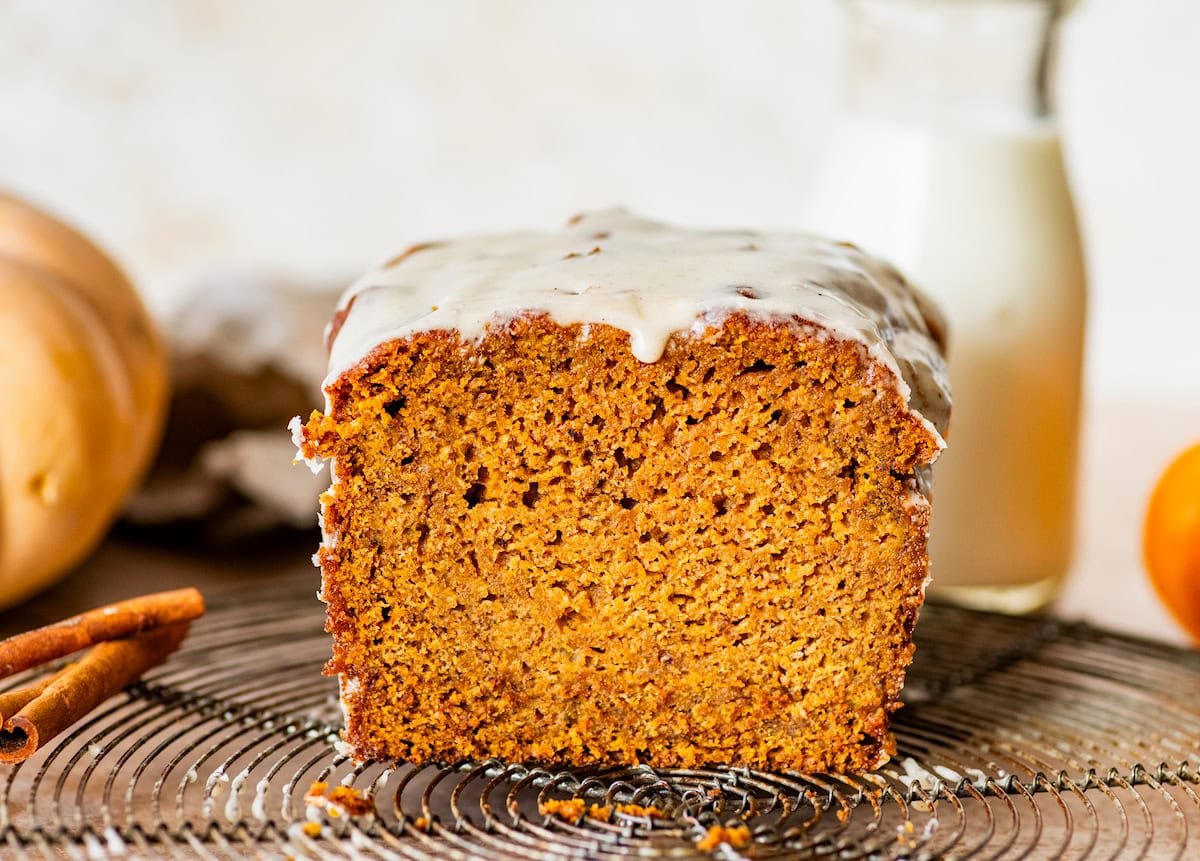 brown butter pumpkin bread with glaze on cooling rack.