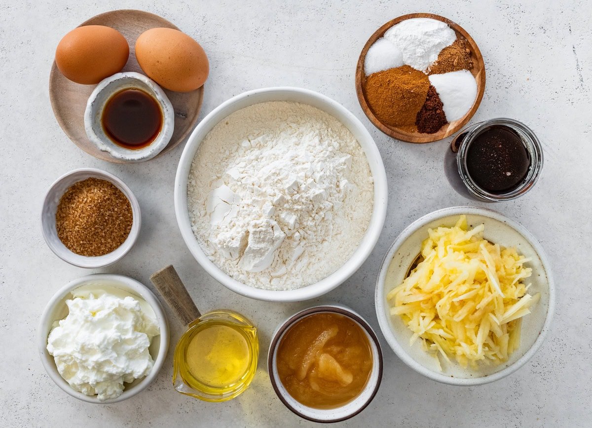 ingredients in bowls to make healthy apple muffins. 