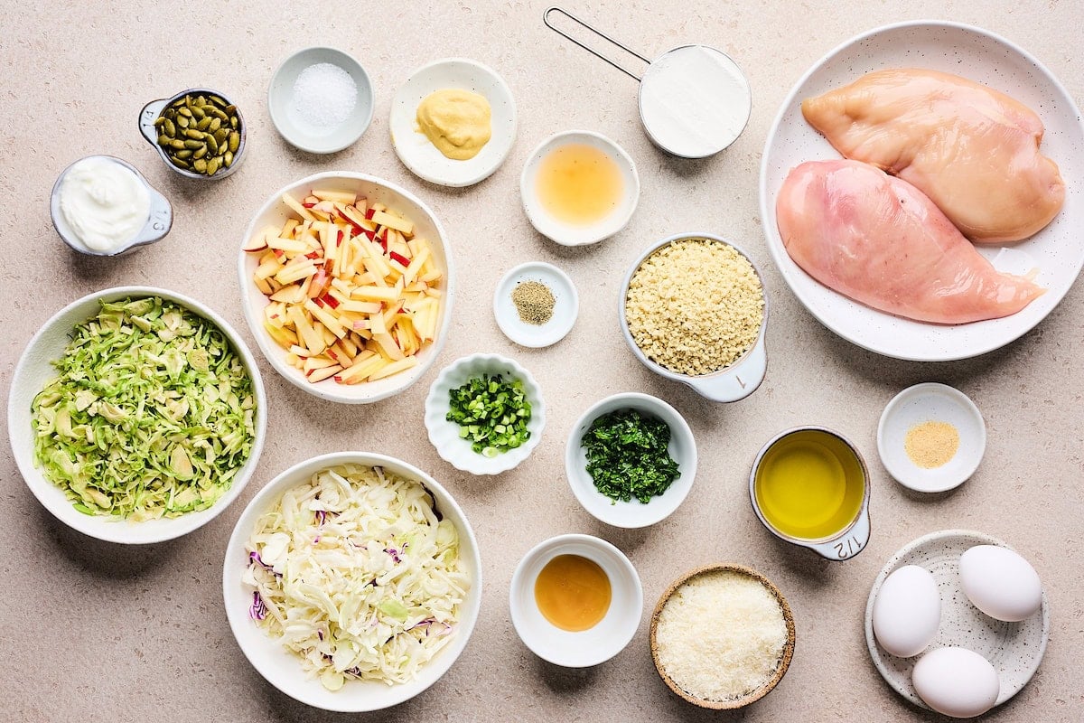 ingredients in bowls to make crispy chicken cutlets with apple slaw.