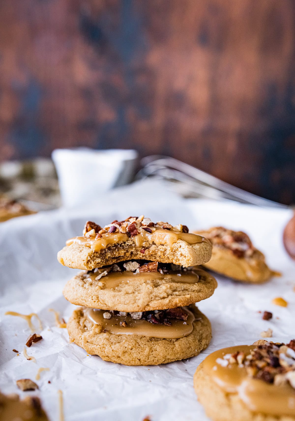 stack of maple pecan cookies on parchment paper. 