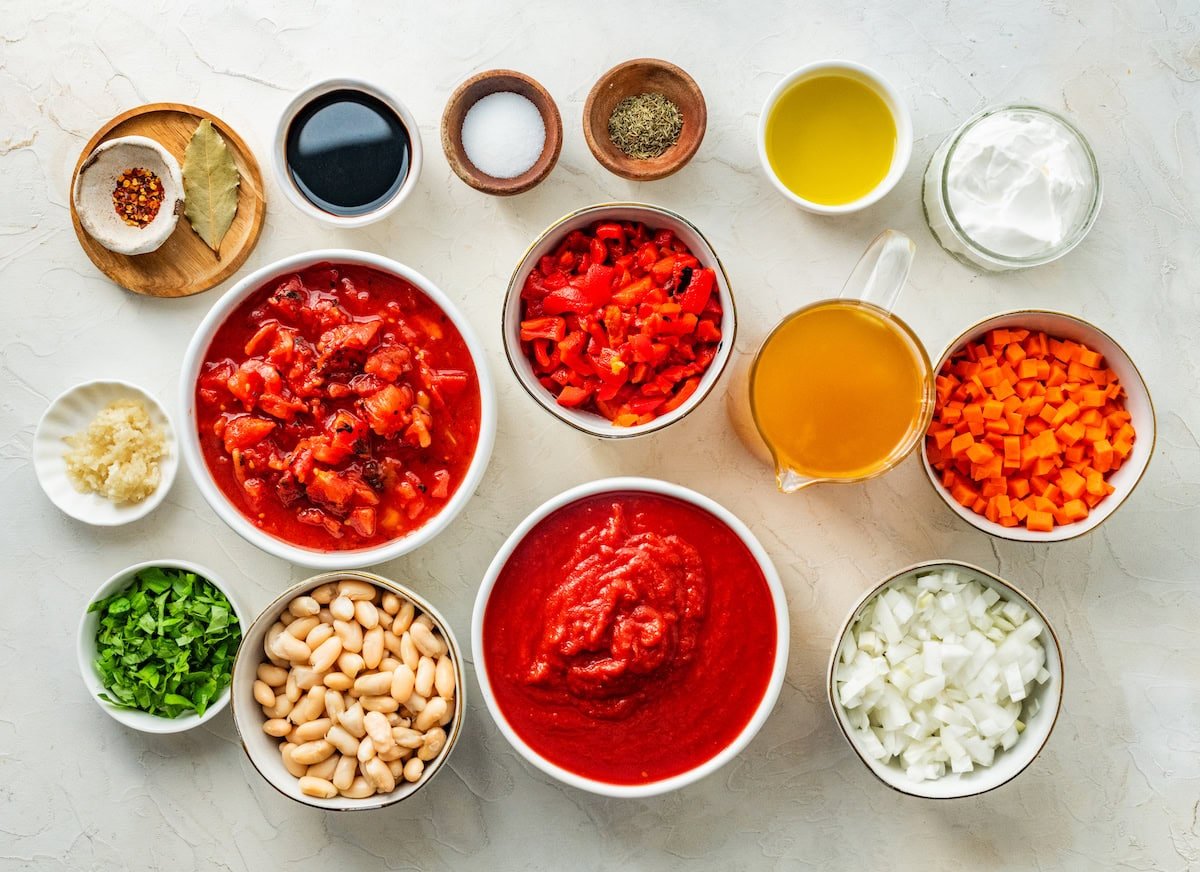 ingredients in bowls to make creamy tomato basil soup.