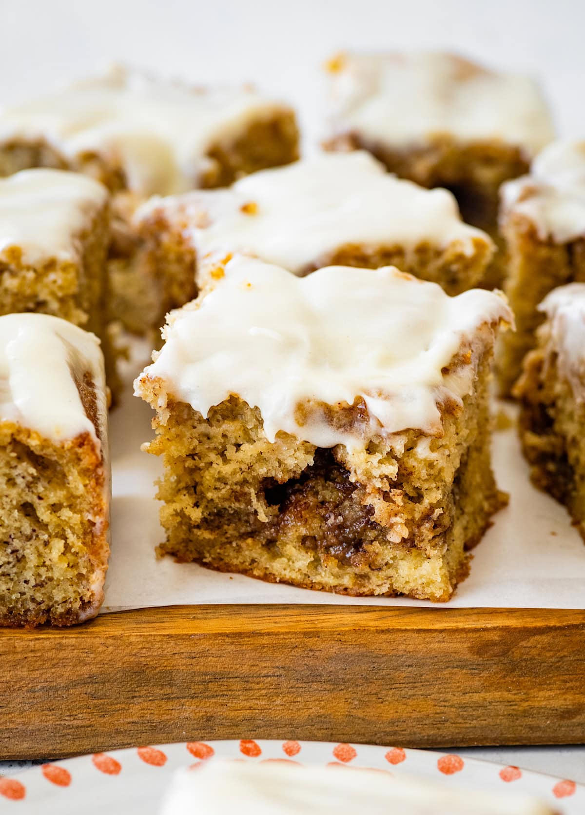 close up of a piece of cinnamon swirl banana cake with cream cheese glaze.