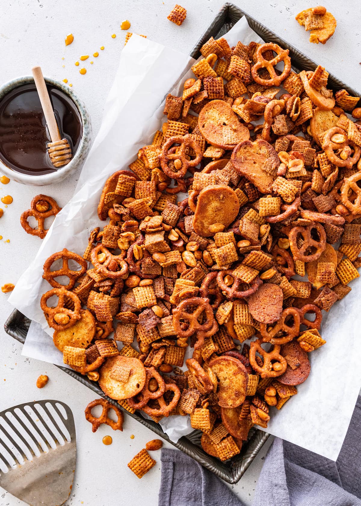 hot honey chex mix on baking sheet with parchment paper.