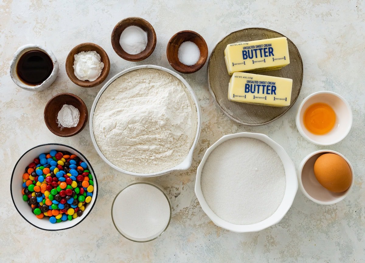 Ingredients in bowls to make M&M sugar cookies.