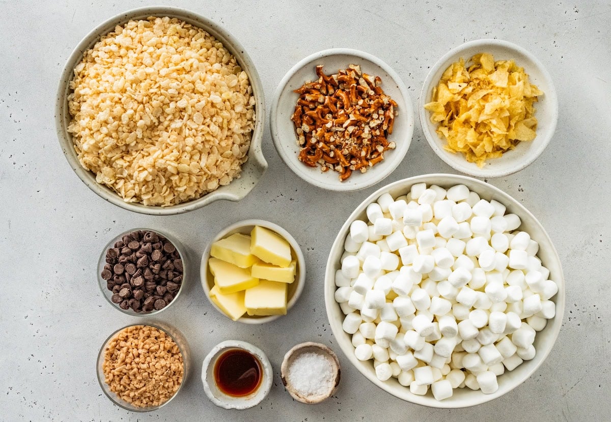 ingredients in bowls to make sweet and salty rice krispie treats.