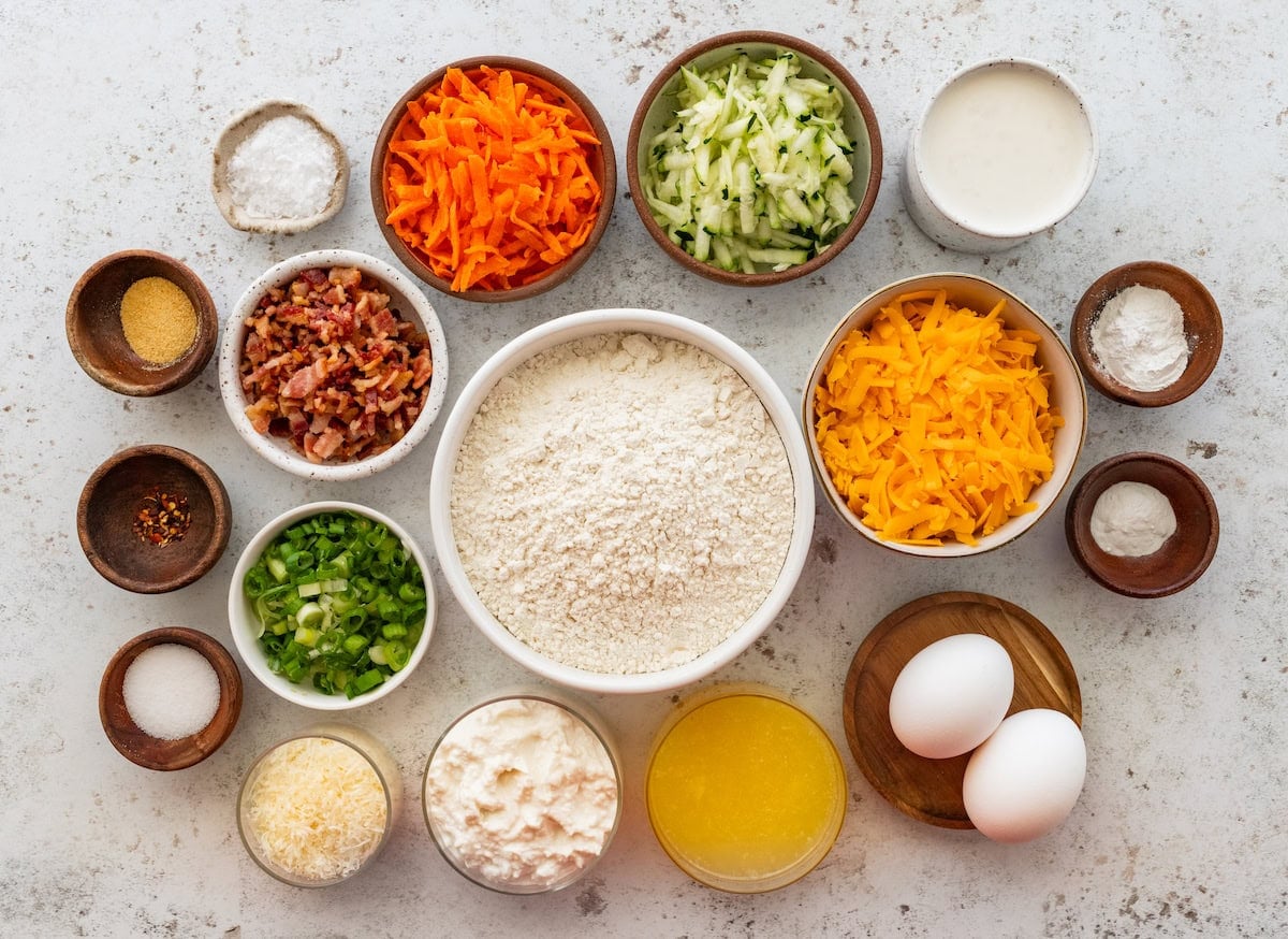 ingredients in bowls to make cheesy savory muffins.