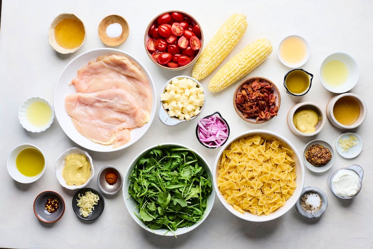 ingredients in bowls to make honey mustard chicken pasta salad.