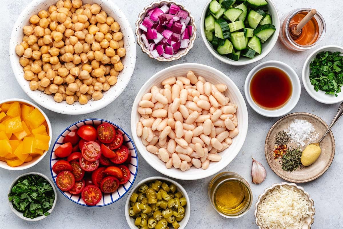 ingredients in bowls to make Italian bean salad.