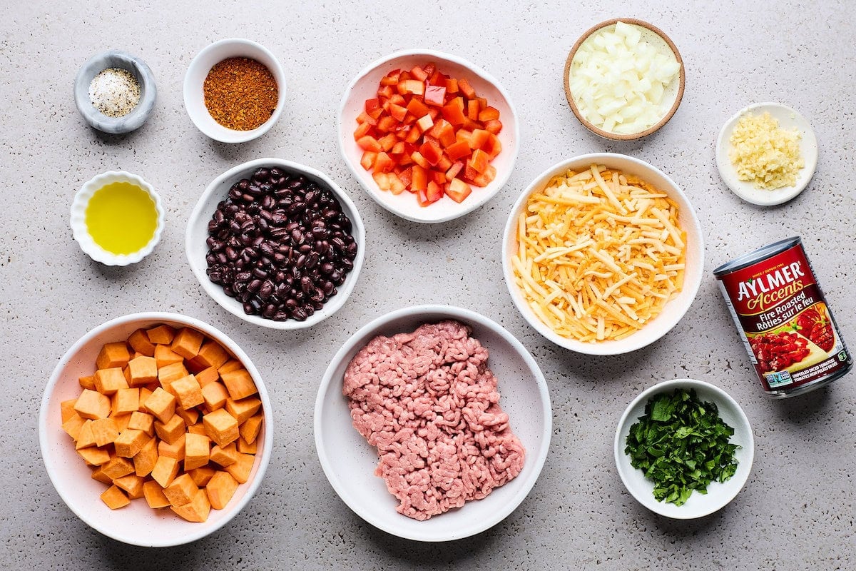 ingredients in bowls to make sweet potato turkey black bean bake.
