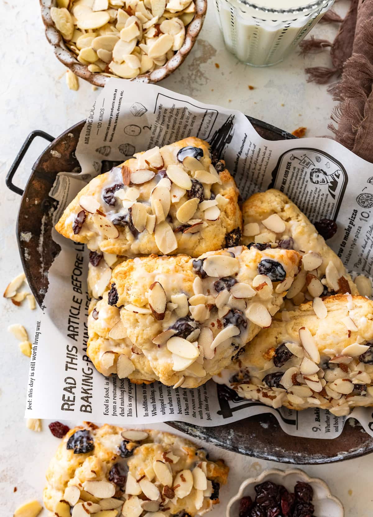 cherry almond scones with almond glaze in basket.