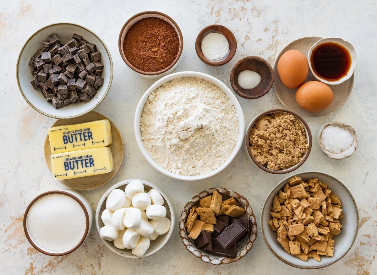 ingredients in bowls to make chocolate s'mores cookies.