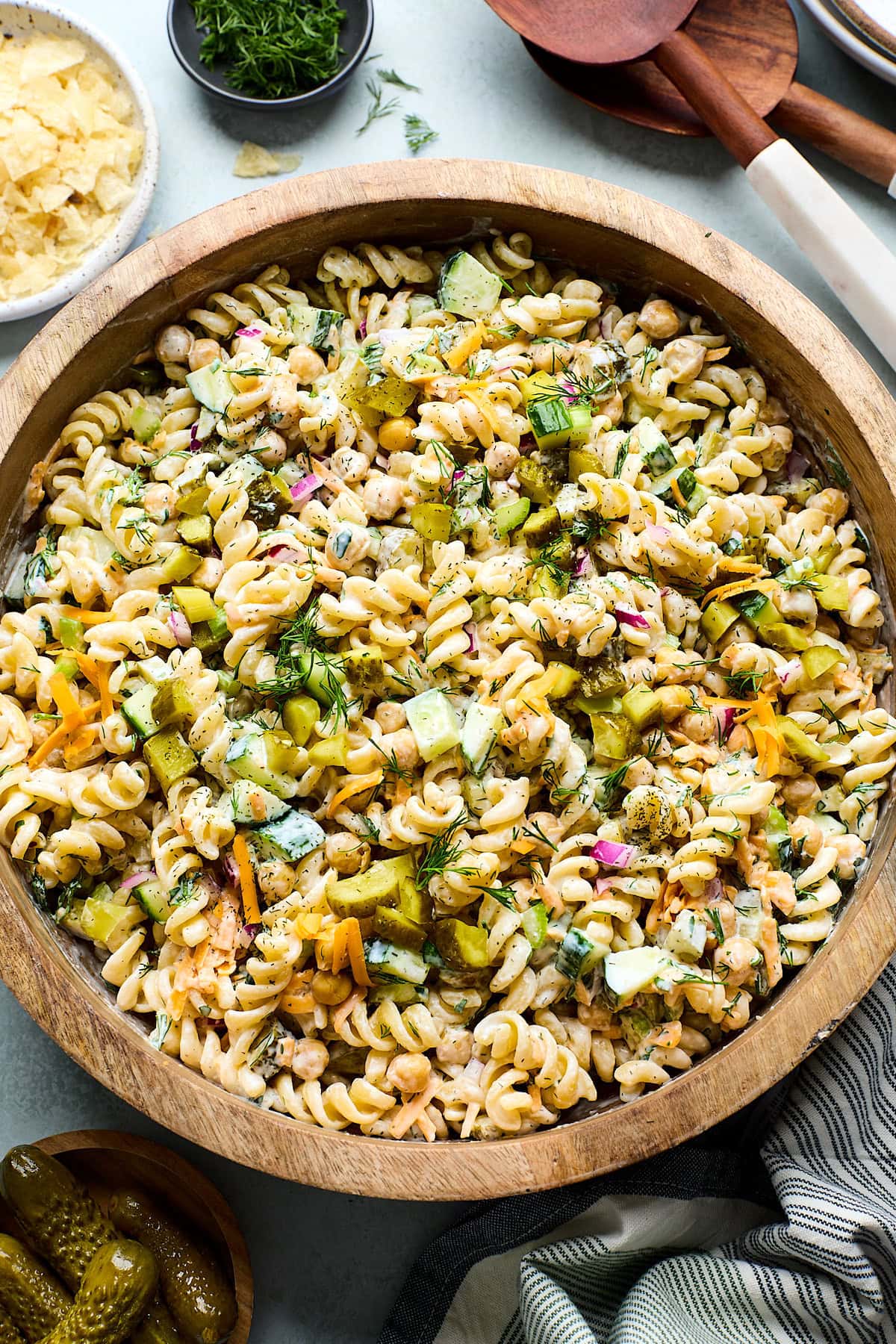 dill pickle pasta salad in wood bowl.
