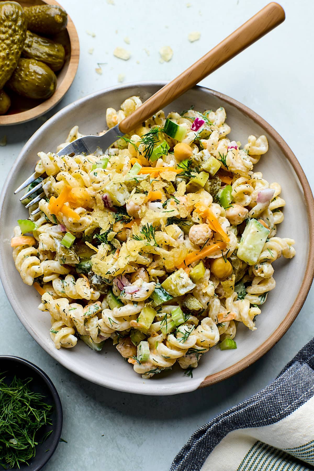 dill pickle pasta salad on plate with fork.