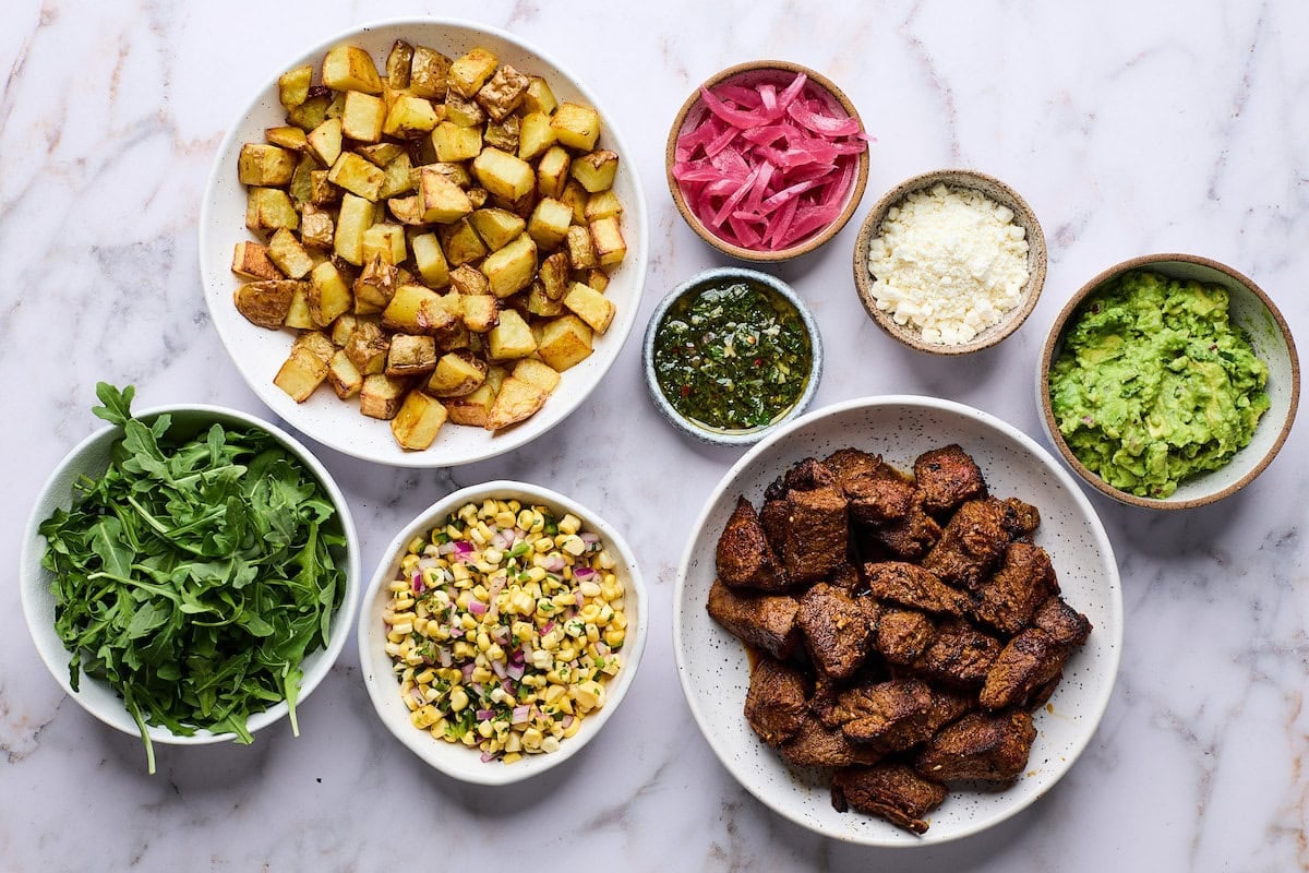 ingredients in bowls to make steak bowls.