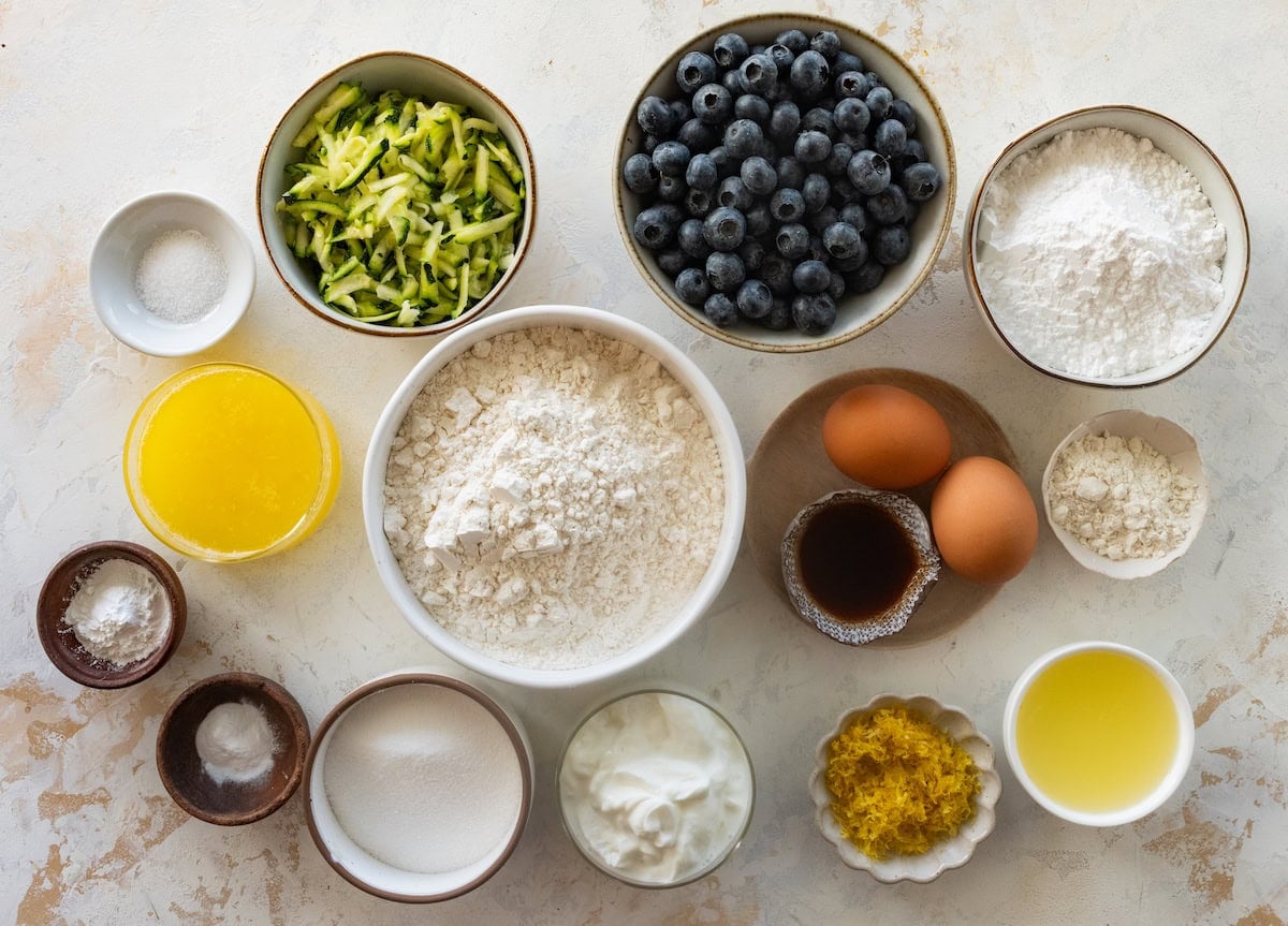 ingredients in bowls to make lemon blueberry zucchini muffins.
