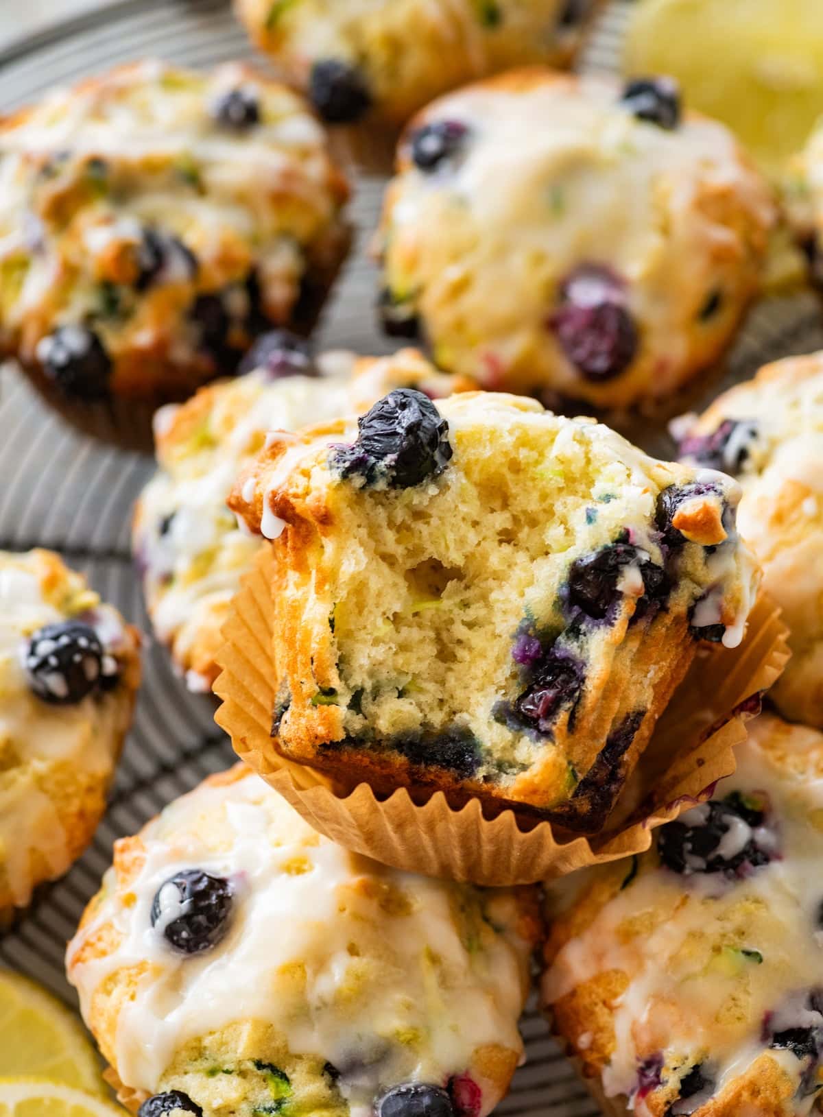close up of the center of a lemon blueberry zucchini muffin with lemon glaze.