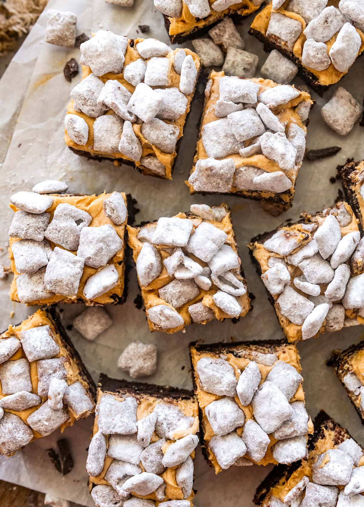 puppy chow brownies with peanut butter frosting and puppy chow on top.