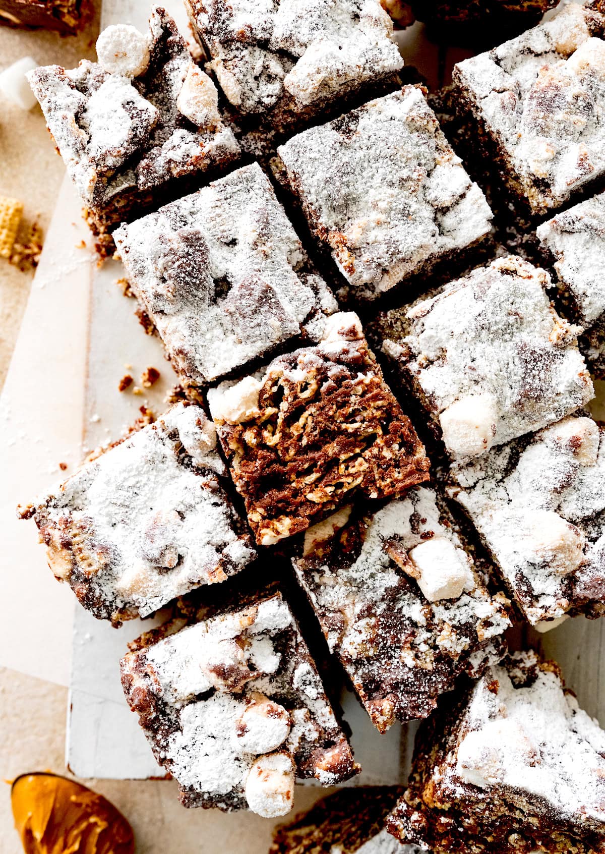 puppy chow marshmallow treats cut into squares.