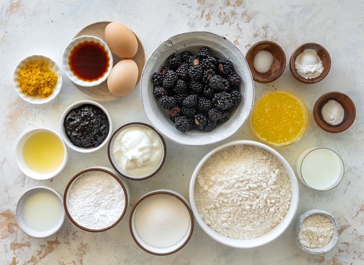 ingredients in bowls to make blackberry muffins.