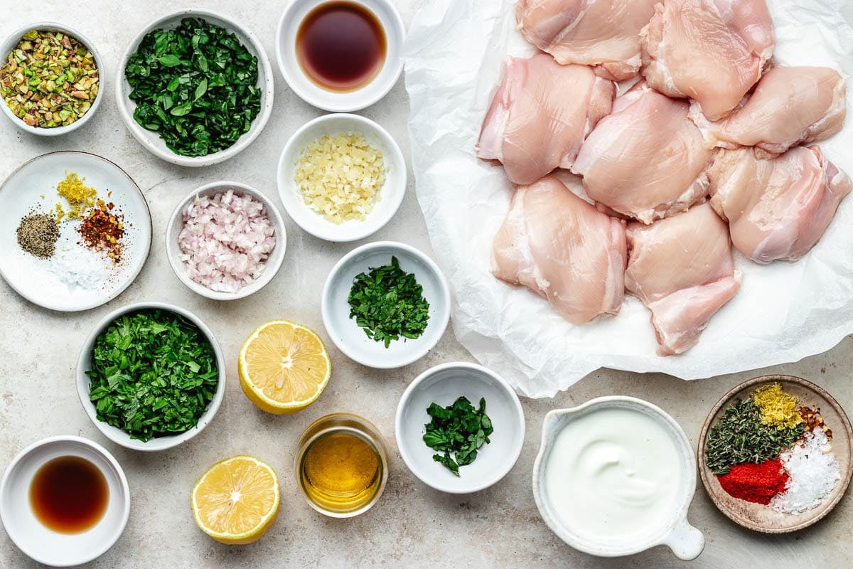 ingredients to make grilled lemon herb chicken thighs with pistachio chimichurri.