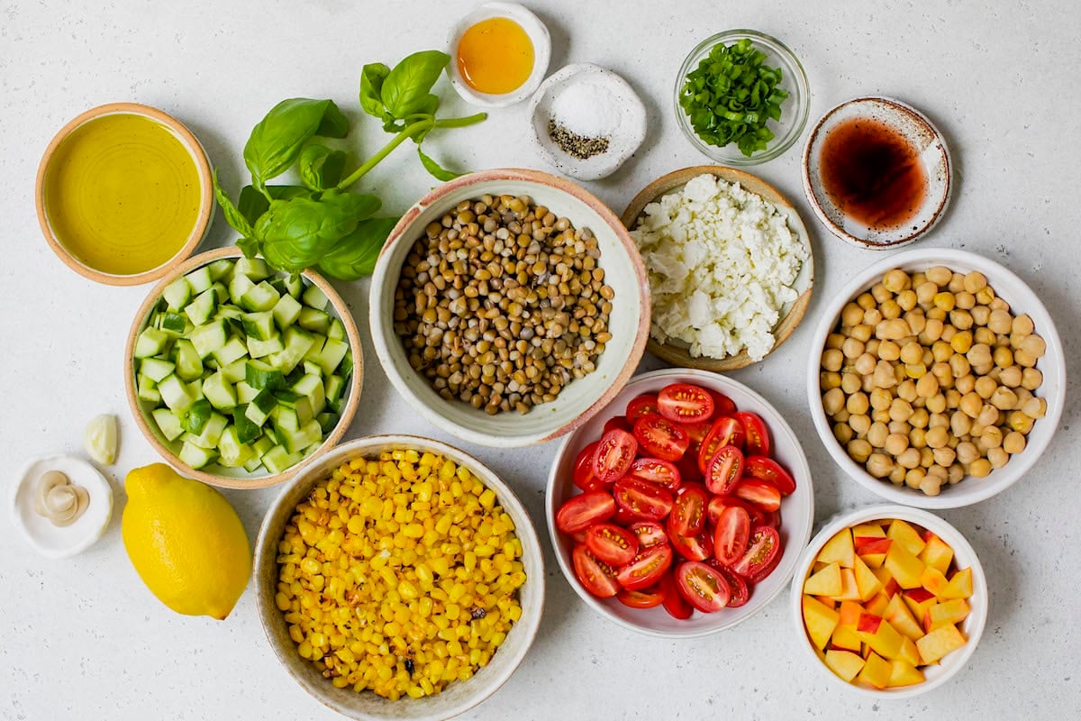 ingredients in bowls to make summer lentil chickpea salad.