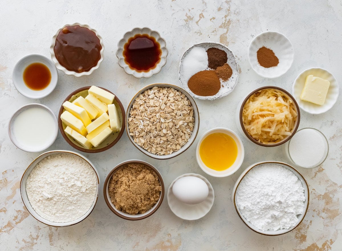 ingredients in bowls to make apple oatmeal cookies with salted caramel glaze.