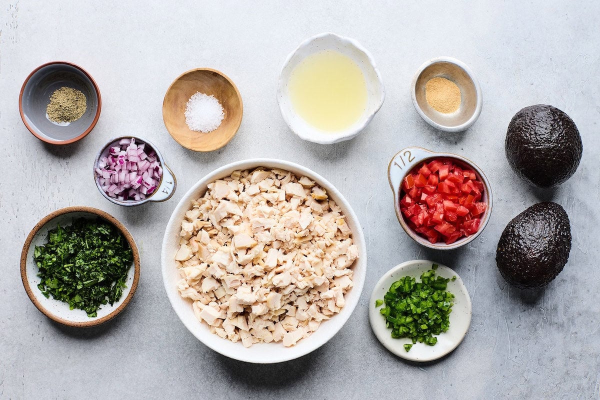 ingredients in bowls to make guacamole chicken salad.