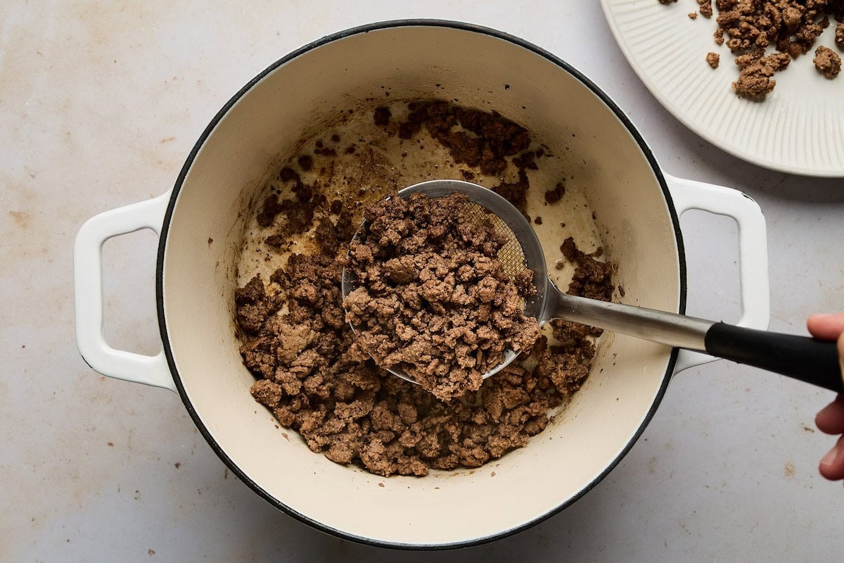 cooking ground beef in pot to make cheeseburger soup.