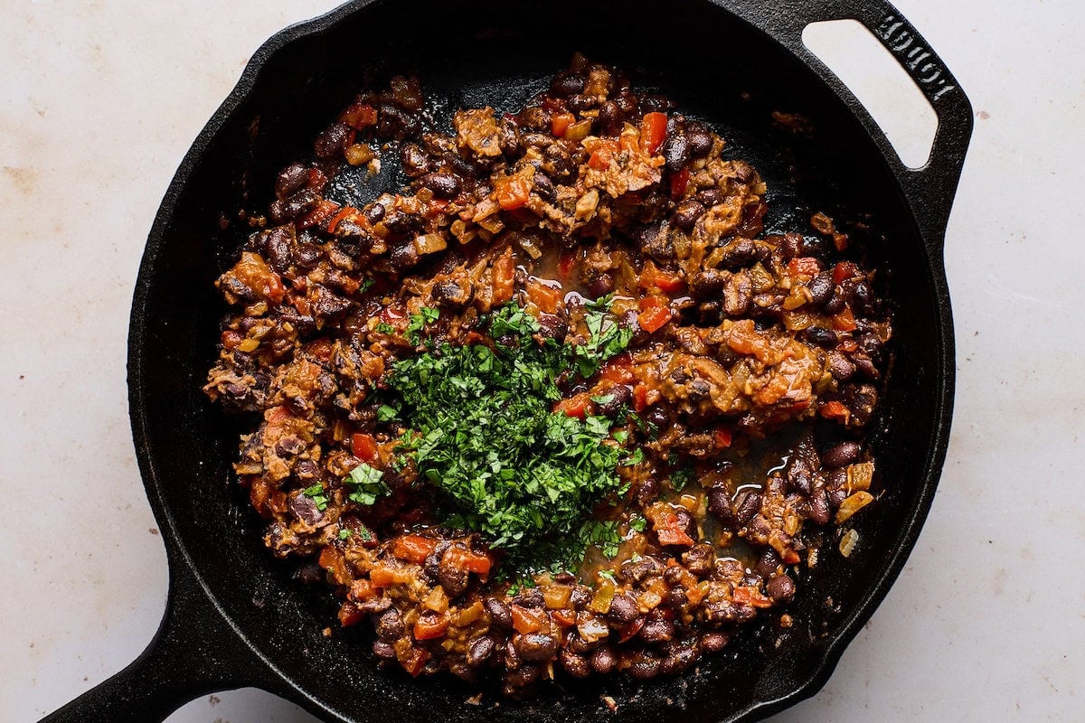 black bean mixture in cast iron skillet to make crispy black bean tacos.