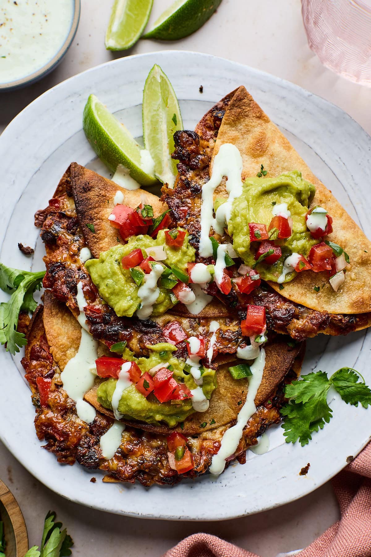 three crispy black tacos on plate with toppings.