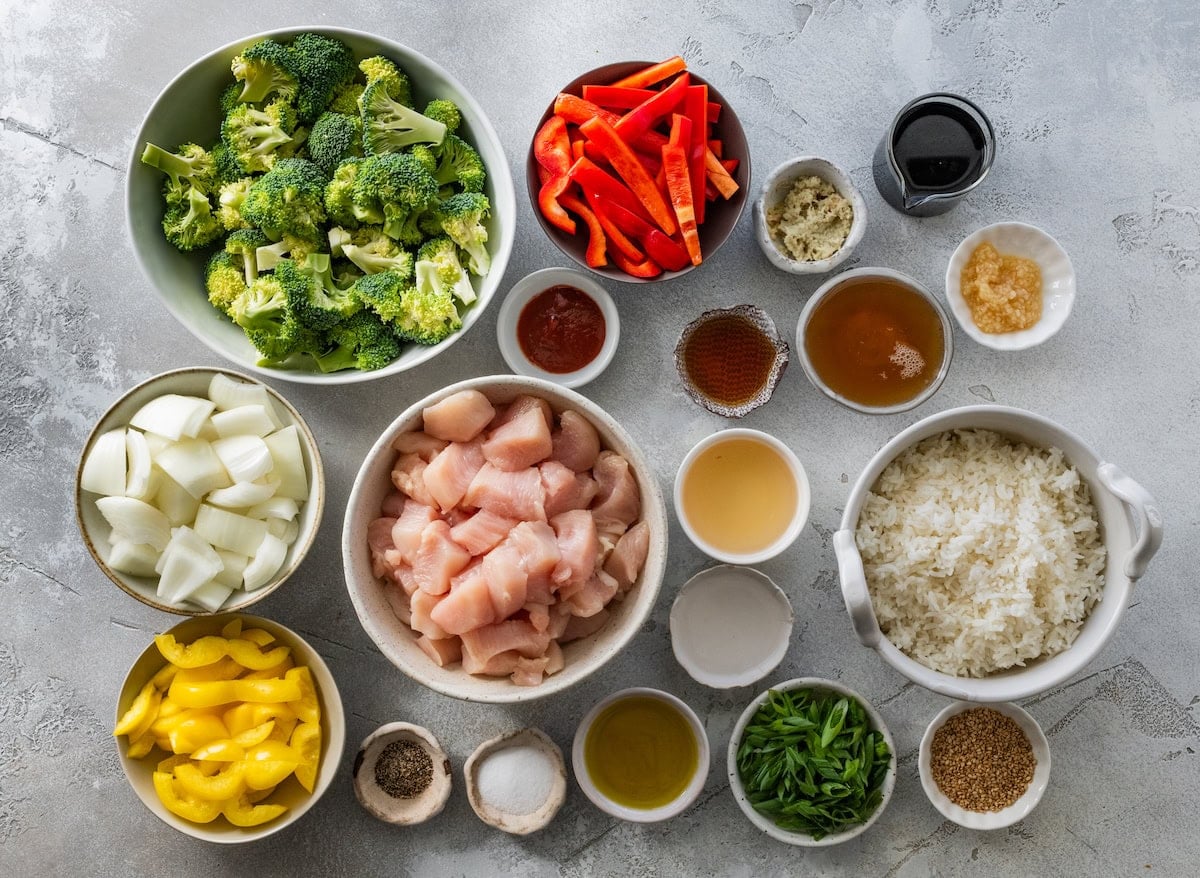 ingredients in bowls to make sheet pan chicken stir fry.