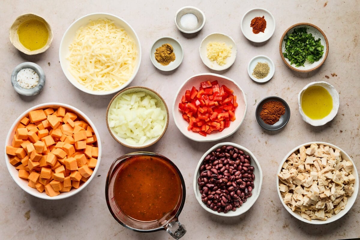 ingredients in bowls to make sweet potato chicken enchilada bake.