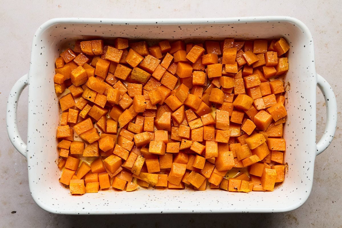 roasted sweet potatoes in baking dish to make sweet potato chicken enchilada bake.