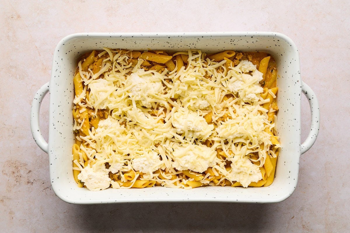 turkey pumpkin pasta bake layered in baking dish.